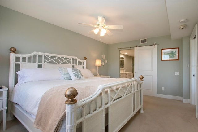 5750 Midnight Pass Rd Unit 203, Sarasota, FL 34242 - bedroom featuring a barn door, light carpet, a ceiling fan, and ensuite bathroom