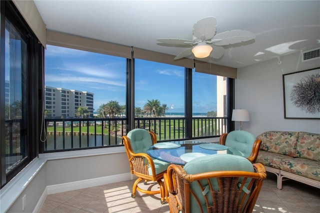 5750 Midnight Pass Rd Unit 203, Sarasota, FL 34242 - sunroom with tile patterned floors and baseboards