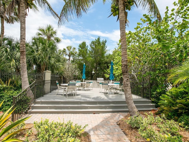 5880 Midnight Pass Rd Unit 202, Sarasota, FL 34242 - view of patio featuring outdoor dining space and a deck