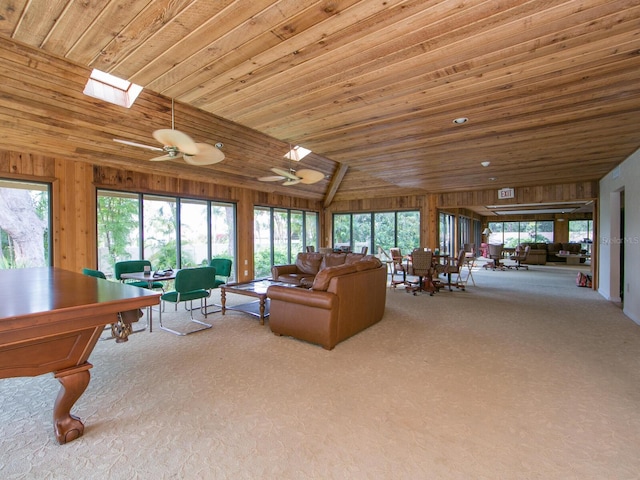5880 Midnight Pass Rd Unit 202, Sarasota, FL 34242 - carpeted living area featuring wooden walls, lofted ceiling, plenty of natural light, wooden ceiling, and ceiling fan