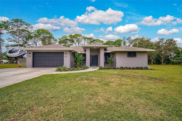 2912 51st St E, Bradenton, FL 34208 - view of front of home with stucco siding, a garage, driveway, and a front lawn