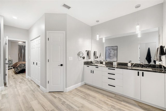 2912 51st St E, Bradenton, FL 34208 - ensuite bathroom with double vanity and wood finished floors