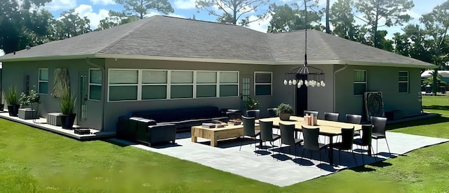 2912 51st St E, Bradenton, FL 34208 - back of property featuring an outdoor living space, a patio area, stucco siding, a yard, and roof with shingles