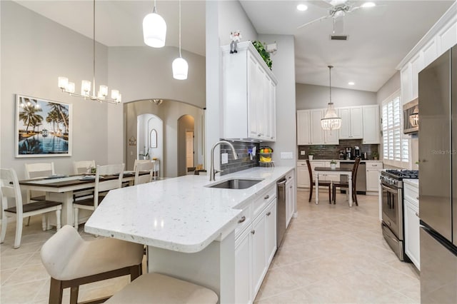 7343 Birds Eye Ter, Bradenton, FL 34203 - kitchen featuring a sink, stainless steel appliances, a chandelier, tasteful backsplash, and white cabinetry