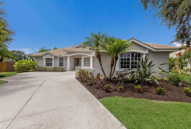 4998 Cedar Oak Way, Sarasota, FL 34233 - single story home featuring a tile roof, stucco siding, and driveway