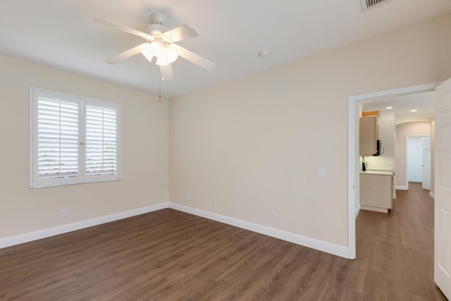 4998 Cedar Oak Way, Sarasota, FL 34233 - spare room featuring wood finished floors, a ceiling fan, and arched walkways