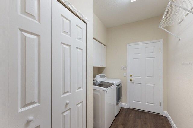 4998 Cedar Oak Way, Sarasota, FL 34233 - laundry area featuring washing machine and clothes dryer, cabinet space, and dark wood-type flooring