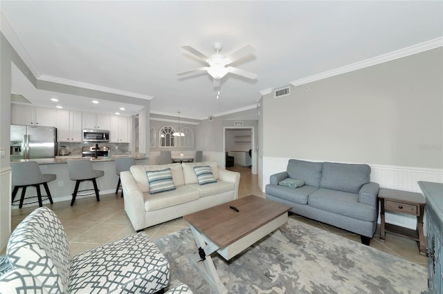 5604 Palmer Cir Unit 103, Bradenton, FL 34211 - living area with ornamental molding, ceiling fan, light tile patterned floors, a wainscoted wall, and a chandelier