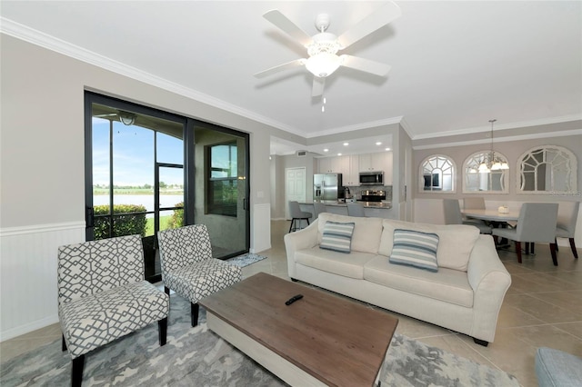 5604 Palmer Cir Unit 103, Bradenton, FL 34211 - living room featuring healthy amount of natural light, light tile patterned floors, ornamental molding, ceiling fan, and wainscoting