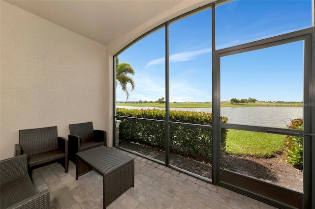 5604 Palmer Cir Unit 103, Bradenton, FL 34211 - sunroom featuring a water view and vaulted ceiling
