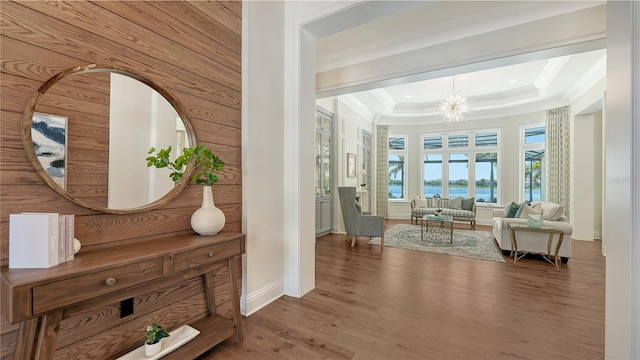 14665 Como Cir, Lakewood Ranch, FL 34202 - corridor featuring crown molding, a raised ceiling, wood finished floors, a chandelier, and recessed lighting