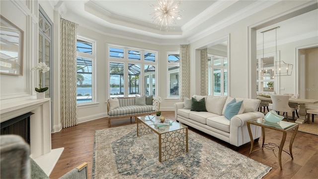 14665 Como Cir, Lakewood Ranch, FL 34202 - living area with a chandelier, dark wood finished floors, ornamental molding, and a premium fireplace