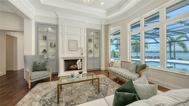 14665 Como Cir, Lakewood Ranch, FL 34202 - living room with a water view, dark wood finished floors, a raised ceiling, and crown molding