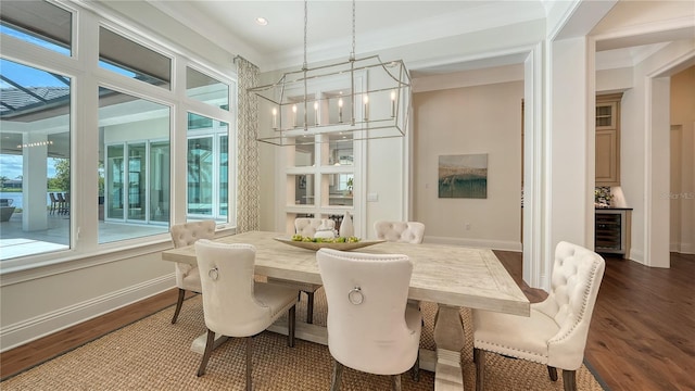 14665 Como Cir, Lakewood Ranch, FL 34202 - dining room featuring beverage cooler, dark wood finished floors, a chandelier, crown molding, and recessed lighting