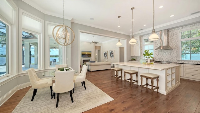 14665 Como Cir, Lakewood Ranch, FL 34202 - dining space featuring ornamental molding, a chandelier, dark wood-style flooring, and recessed lighting