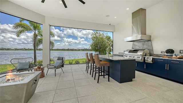 14665 Como Cir, Lakewood Ranch, FL 34202 - view of patio / terrace featuring an outdoor fire pit, an outdoor kitchen, a water view, and ceiling fan