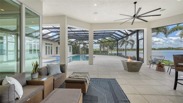 14665 Como Cir, Lakewood Ranch, FL 34202 - view of patio with a water view, an outdoor living space with a fire pit, a lanai, and a ceiling fan