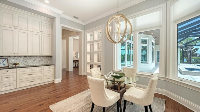 14665 Como Cir, Lakewood Ranch, FL 34202 - dining space with a chandelier, dark wood-type flooring, and crown molding