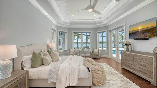 14665 Como Cir, Lakewood Ranch, FL 34202 - bedroom featuring access to outside, french doors, dark wood-style floors, a tray ceiling, and ornamental molding