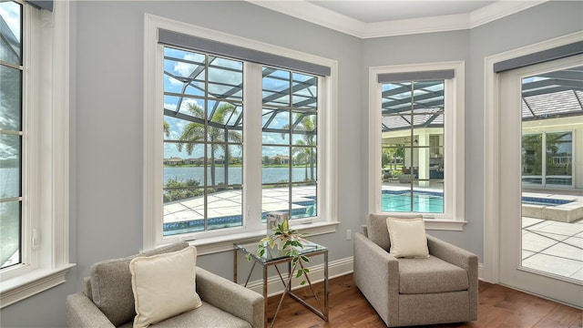 14665 Como Cir, Lakewood Ranch, FL 34202 - sitting room with a water view, wood finished floors, plenty of natural light, and crown molding