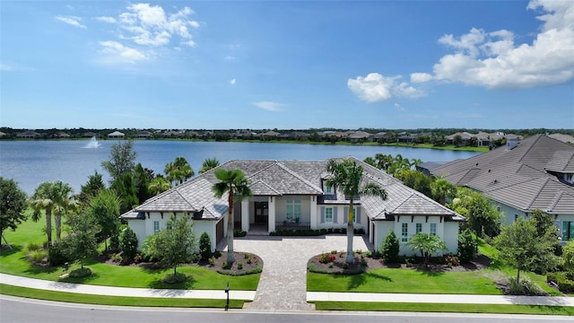 14665 Como Cir, Lakewood Ranch, FL 34202 - view of front of home featuring decorative driveway, stucco siding, a water view, and a front yard