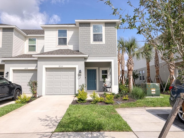 8733 Winter Breeze Way, Sarasota, FL 34241 - view of property with driveway, an attached garage, a shingled roof, and stucco siding