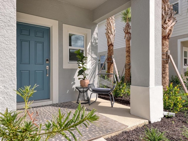 8733 Winter Breeze Way, Sarasota, FL 34241 - entrance to property featuring stucco siding and a porch