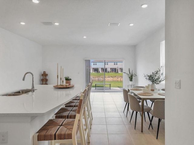 8733 Winter Breeze Way, Sarasota, FL 34241 - kitchen with a sink, plenty of natural light, light tile patterned flooring, light countertops, and recessed lighting