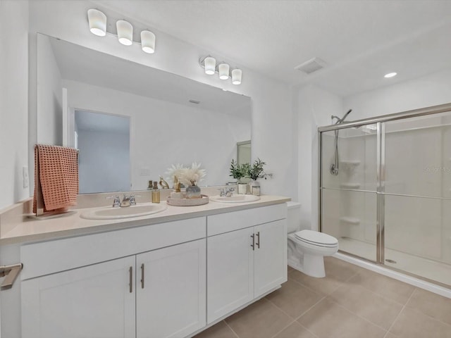 8733 Winter Breeze Way, Sarasota, FL 34241 - bathroom featuring double vanity, a shower stall, toilet, and tile patterned floors