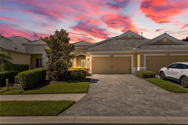 2070 Crystal Lake Trl, Bradenton, FL 34211 - view of front of property featuring a garage, decorative driveway, stucco siding, and a tile roof
