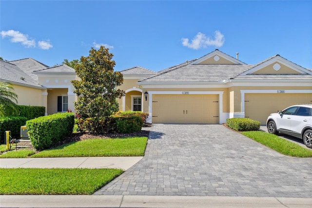 2070 Crystal Lake Trl, Bradenton, FL 34211 - view of front facade featuring a garage, decorative driveway, stucco siding, and a tiled roof