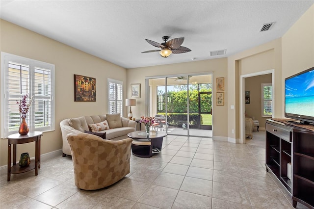 2070 Crystal Lake Trl, Bradenton, FL 34211 - living area featuring ceiling fan, light tile patterned floors, and a textured ceiling