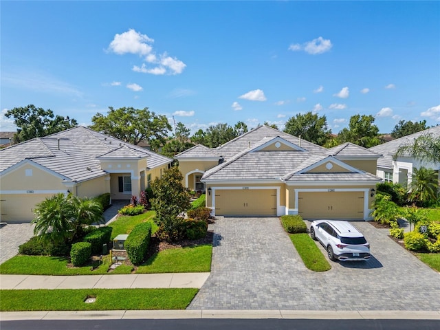 2070 Crystal Lake Trl, Bradenton, FL 34211 - view of front of house with stucco siding, a garage, and decorative driveway