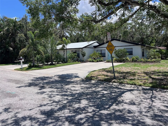 1840 3rd Ave E, Bradenton, FL 34208 - ranch-style house featuring driveway, a chimney, and view of scattered trees