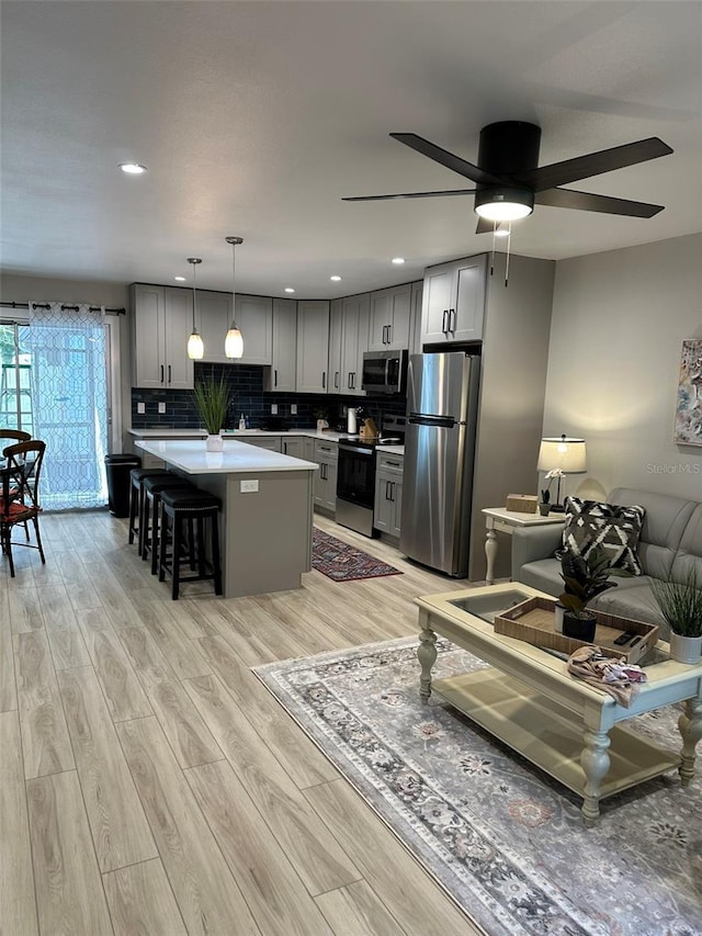 1840 3rd Ave E, Bradenton, FL 34208 - living area featuring light wood finished floors, ceiling fan, and recessed lighting