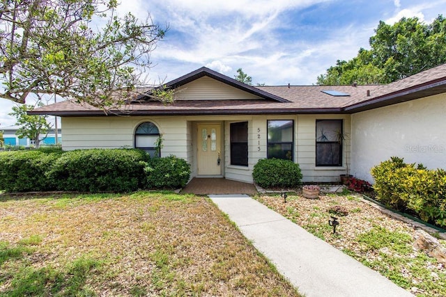 5213 20th Street Ct E, Bradenton, FL 34203 - view of front of house featuring a front lawn and roof with shingles