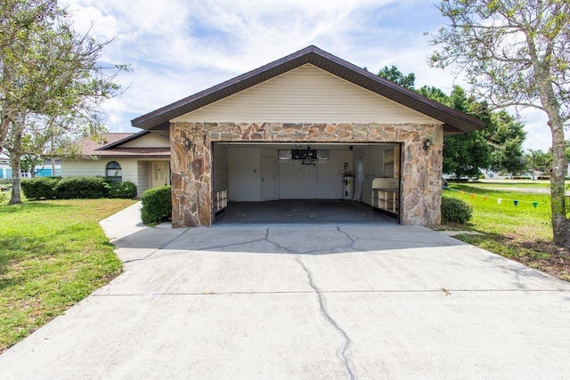 5213 20th Street Ct E, Bradenton, FL 34203 - view of side of property with stone siding, concrete driveway, a yard, an attached garage, and electric water heater