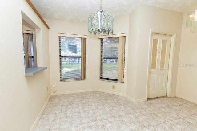 5213 20th Street Ct E, Bradenton, FL 34203 - empty room with a chandelier, a textured ceiling, and tile patterned floors