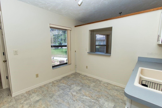5213 20th Street Ct E, Bradenton, FL 34203 - unfurnished dining area featuring baseboards and stone finish floors