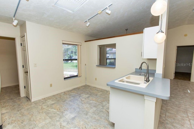 5213 20th Street Ct E, Bradenton, FL 34203 - kitchen with rail lighting, white cabinets, light countertops, and decorative light fixtures