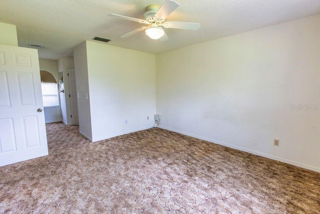 5213 20th Street Ct E, Bradenton, FL 34203 - carpeted spare room with ceiling fan, arched walkways, and a textured ceiling