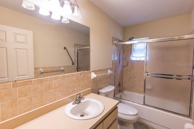 5213 20th Street Ct E, Bradenton, FL 34203 - full bathroom featuring vanity, bath / shower combo with glass door, and tile walls
