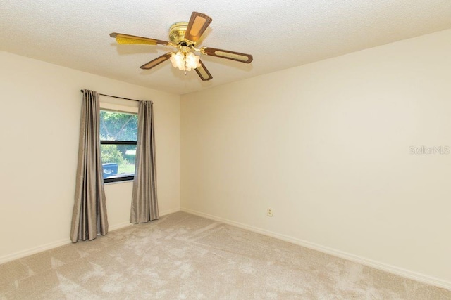 5213 20th Street Ct E, Bradenton, FL 34203 - empty room featuring light colored carpet, a ceiling fan, and a textured ceiling