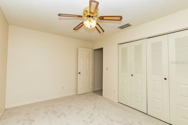 5213 20th Street Ct E, Bradenton, FL 34203 - unfurnished bedroom with light colored carpet, a closet, ceiling fan, and a textured ceiling