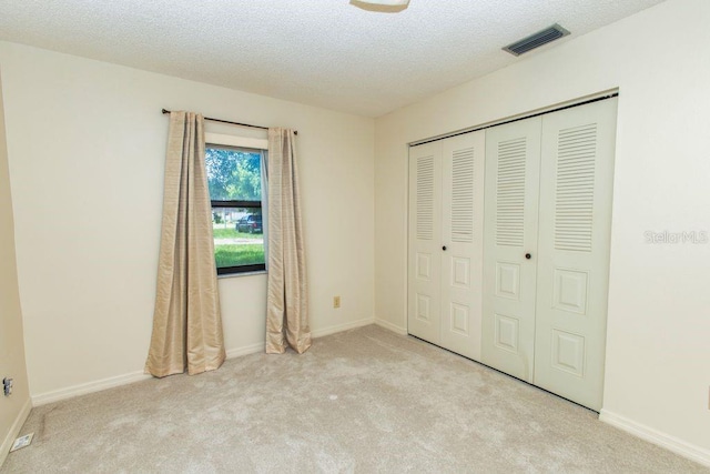 5213 20th Street Ct E, Bradenton, FL 34203 - unfurnished bedroom with carpet floors, a closet, and a textured ceiling