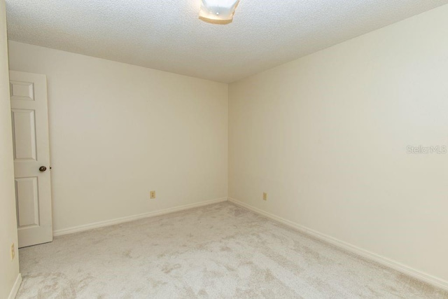 5213 20th Street Ct E, Bradenton, FL 34203 - unfurnished room featuring light carpet and a textured ceiling
