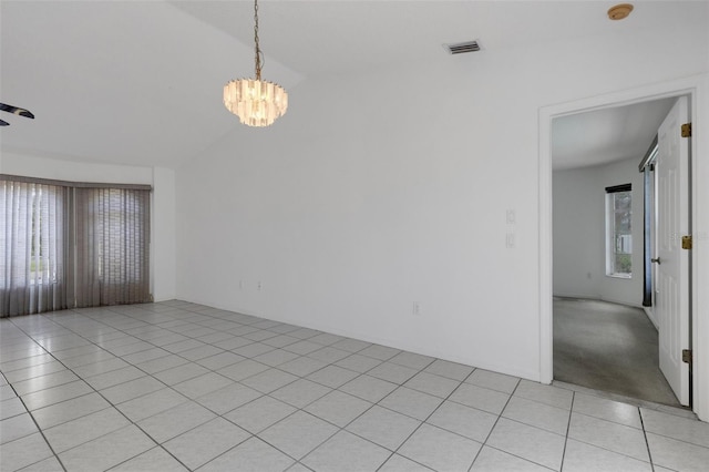 1026 Graham Rd, Venice, FL 34293 - spare room with lofted ceiling, a chandelier, a smoke detector, and light tile patterned floors