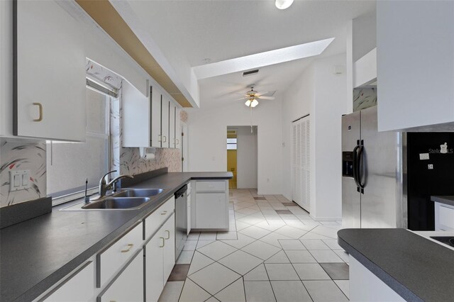 1026 Graham Rd, Venice, FL 34293 - kitchen featuring a ceiling fan, dark countertops, white cabinets, and backsplash