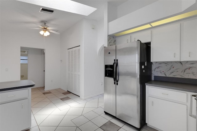 1026 Graham Rd, Venice, FL 34293 - kitchen featuring stainless steel refrigerator with ice dispenser, dark countertops, ceiling fan, and white cabinetry
