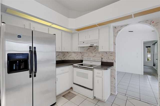 1026 Graham Rd, Venice, FL 34293 - kitchen with stainless steel refrigerator with ice dispenser, white electric range oven, under cabinet range hood, dark countertops, and arched walkways
